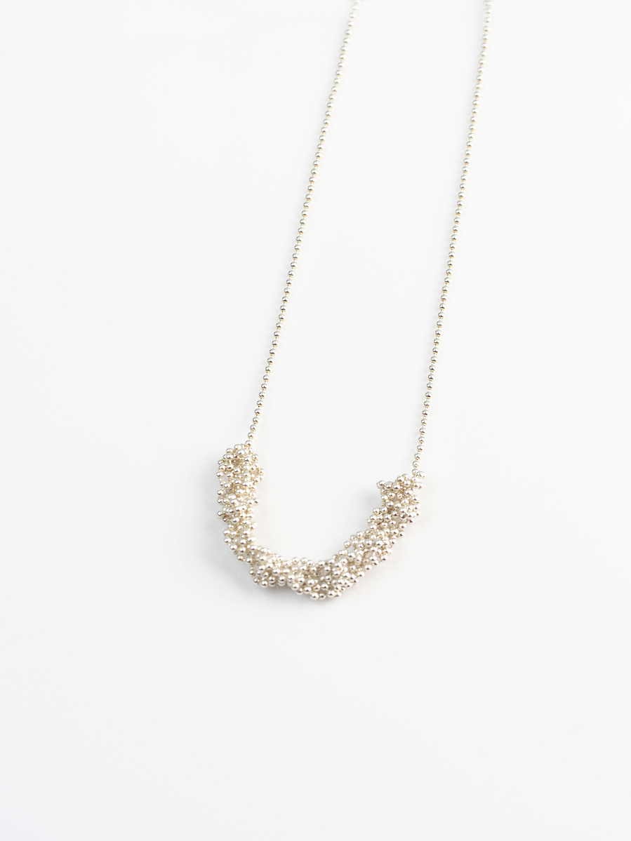 Handmade sterling silver pendant from the Knit 1 Purl 1 [K1 P1] series on a white background by contemporary jeweller Di Allison of HALLISON Studios, Tasmania. Features beaded sterling silver.