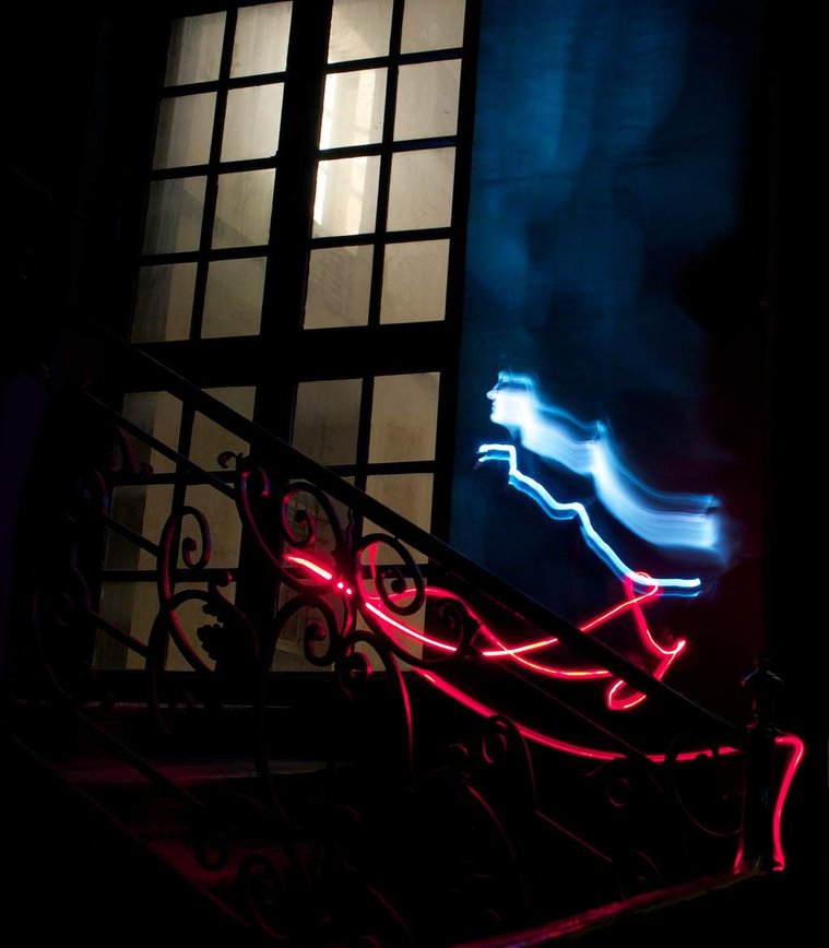Fine art photograph by Di Allison, HALLISON Studios, Tasmania, online gallery store. Evanescence:  ghostly portrait , dark, ornate staircase in Paris, red light painting,  woman's face in blue light, ascends stairs, gothic mood,  large French windows.