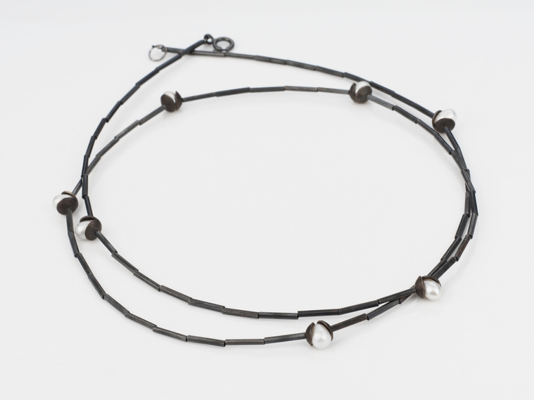 Nestle Luminous Flourish necklace, by contemporary jewellery by artist Di Allison, HALLISON Studios, Tasmania online gallery store. Oxidised, domed sterling silver, white freshwater pearls, on a sterling like flower buds.