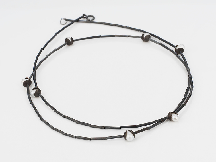 Nestle Luminous Flourish necklace, by contemporary jewellery by artist Di Allison, HALLISON Studios, Tasmania online gallery store. Oxidised, domed sterling silver, white freshwater pearls, on a sterling like flower buds.