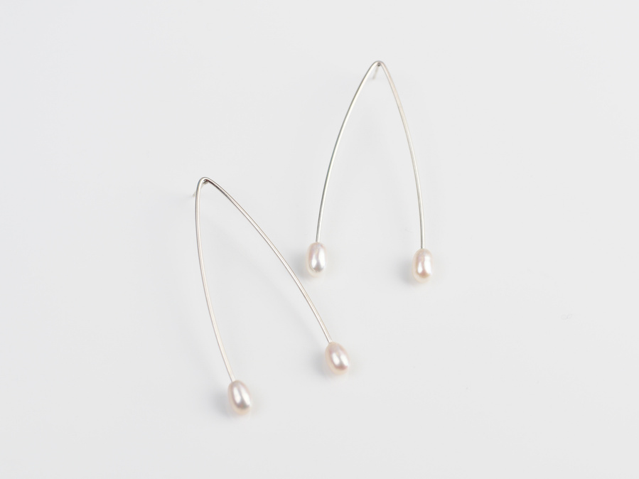 Sterling silver and white freshwater pearl stud earrings entitled Wish, against a white background. Made by contemporary jeweller Di Allison, HALLISON Studios, Tasmania. These earrings feature 4 pearls and take the shape of wish bones. 
