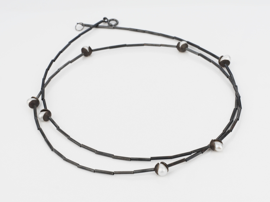 Inspired by nature the Flourish necklace features 7 luminous freshwater pearls nestled, like flower buds, amongst domed and oxidised sterling silver - this piece can be worn long or wrapped and is by contemporary jeweller Di Allison, HALLISON Studios.