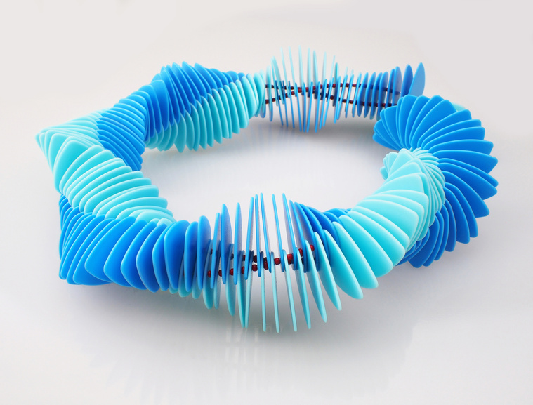 Quaver contemporary jewellery series inspired by pop songs, rock songs, music. Jean Genie necklace made from blue guitar pics twisted like strands of dna inspired by David Bowie.Jeweller Di Allison, HALLISON Studios, Tasmania.