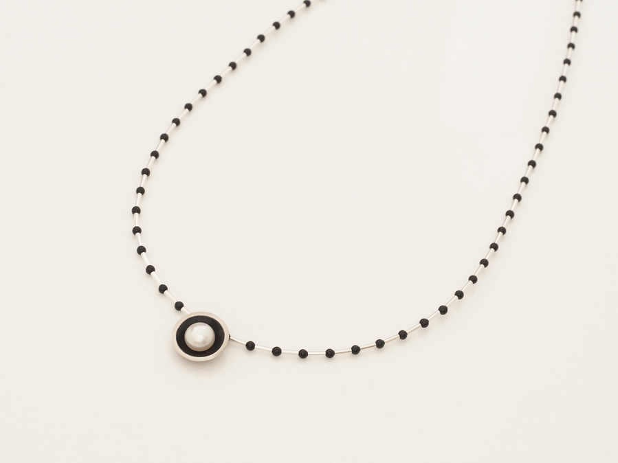 Classic and contemporary connect in this round sterling silver and kiln fired black vitreous enamel pendant, set with a round luminous freshwater pearl.  Made by jeweller Diane Allison, HALLISON Studios, Tasmania, from the Connect the Dots collection.