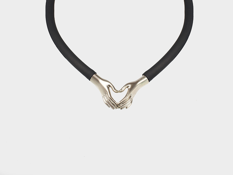 Contemporary jewellery by Di Allison, HALLISON Studios, Tasmania, online gallery. Still Your Hands and Still Your Heart pendant inspired by Nick Cave song lyric, features sterling silver hands forming a love heart.