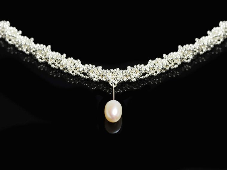 Knit 1 Purl1 K1P1 necklace by contemporary jeweller Di Allison, HALLISON Studios, Tasmania, online gallery store. This sterling silver handmade necklace features a white freshwater pearl droplet and is reminiscent of a DNA strand.