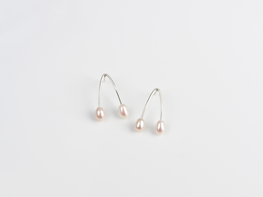 Sterling silver and white freshwater pearl stud earrings entitled Wish, against a white background. Made by contemporary jeweller Di Allison, HALLISON Studios, Tasmania. These earrings feature 4 pearls and take the shape of wish bones. 