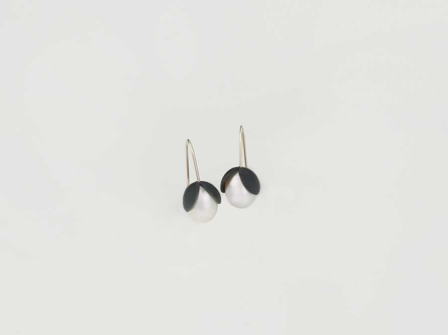 Nestle: Luminous earrings featuring white freshwater pearls nestled between oxidised and domed sterling silver by  contemporary jeweller Di Allison of HALLISON Studios, Tasmania.