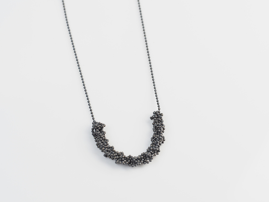 Handmade sterling silver pendant from the Knit 1 Purl 1 [K1 P1] series on a white background by contemporary jeweller Di Allison of HALLISON Studios, Tasmania. Features oxidised beaded sterling silver.