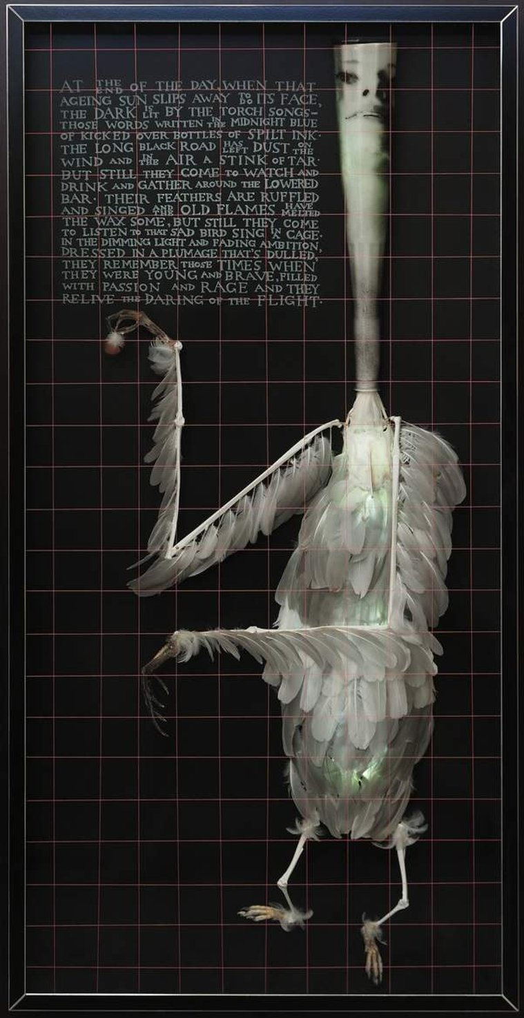 The Torch Song by contemporary artist Patrick Hall, HALLISON Studios, Tasmania, online gallery. Sculpture of white feathers, a figure with the face of Judy Garland, the head is white spirit bottle. Poetry, prose engraved on glass.