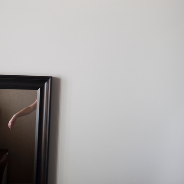 Fine art photographic print by artist Diane Allison, HALLISON Studios of a woman's arm reflected in a framed mirror of a hotel room, Brunswick St Gallery
