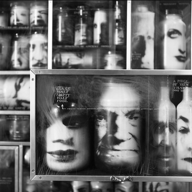 All Our Numbered Days, sculptural furniture, chest of drawers by Tasmanian artist Patrick Hall, HALLISON Studios. Cabinet of glass bottles each with a photographic face. Shown at Sydney Contemporary, acquired by  University of Tasmania Fine Art Collection