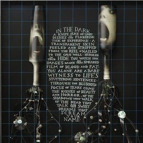 The Bare Witness, contemporary art, Tasmanian Patrick Hall, HALLISON Studios. Glowing bottles with faces. Shelley Duvall screaming in horror movie The Shining. Sculptural human figures of 16 mm film strip, engraved poetry, prose on glass at Dark MOFO