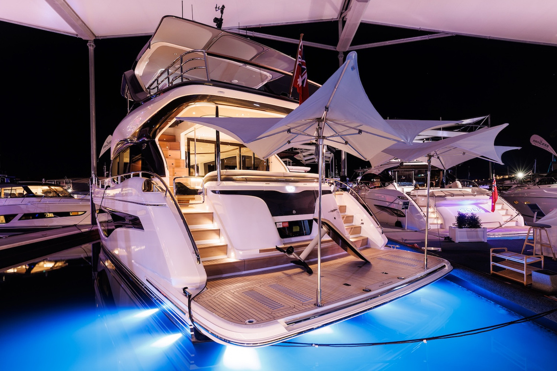 The Princess Yachts Y72 under lights at night during the Sanctuary Cove International Boat Show. Boat show photography by yacht photographer Darren Gill.