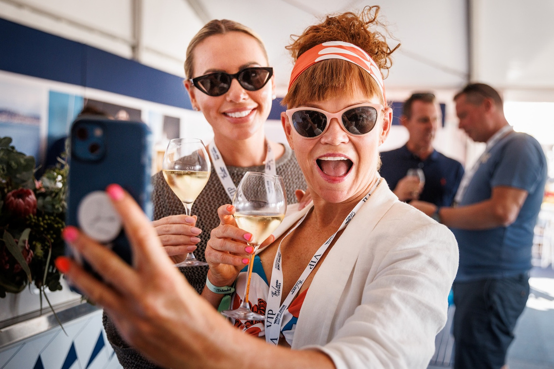 Guests enjoying the hospitality at the Princess Yachts display at Sanctuary Cove International Boat Show. Boat show event photography by yacht photographer Darren Gill.