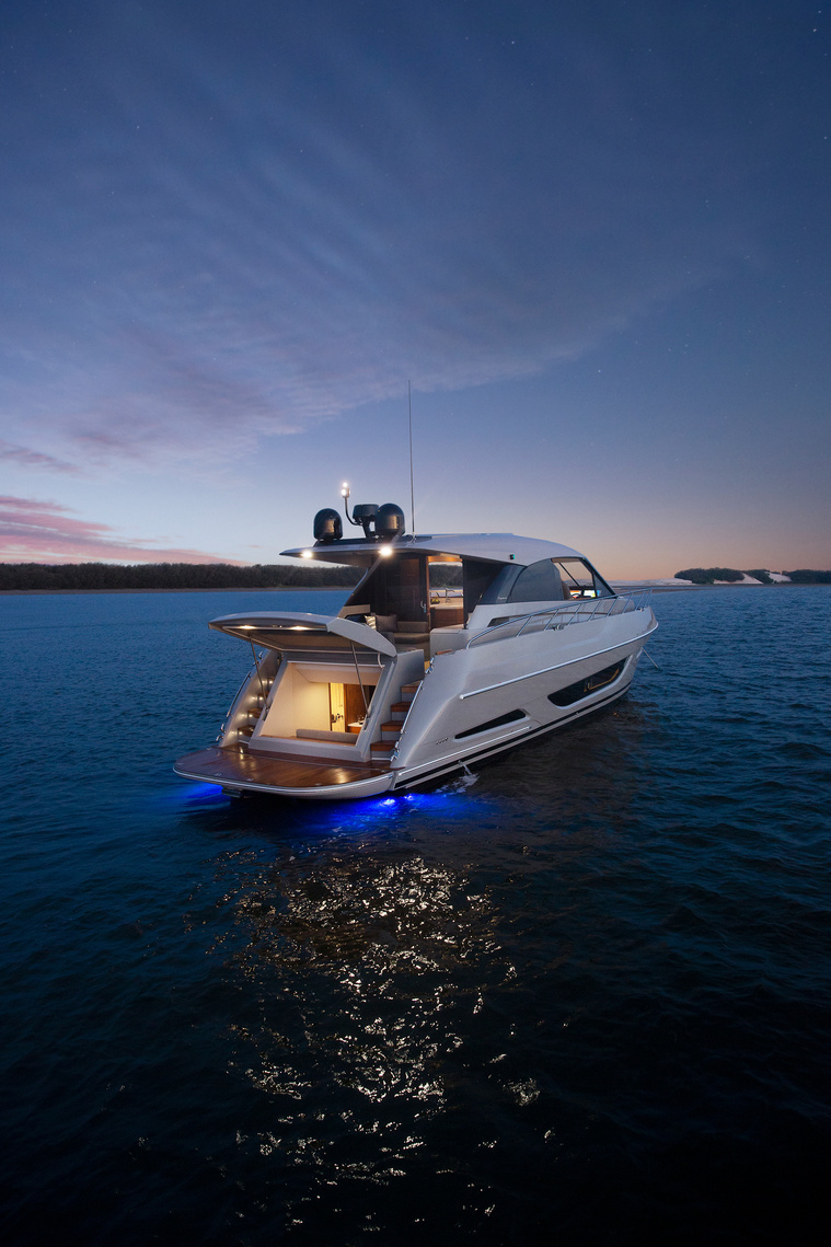 Maritimo X50 luxury motor yacht at night under a starry sky with the beach club open anchored off an island in Queensland, Australia. Boat photography by Darren Gill