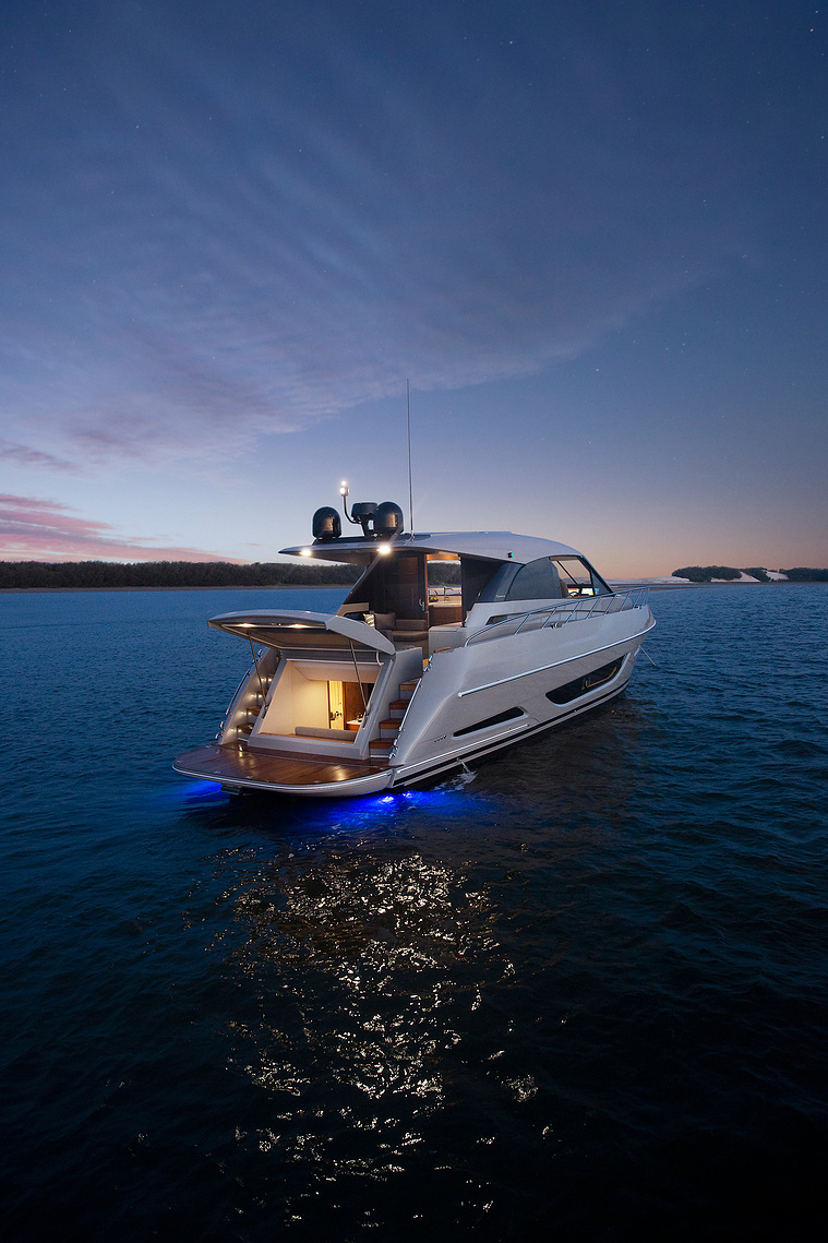 Maritimo X50 luxury motor yacht at night under a starry sky with the beach club open anchored off an island in Queensland, Australia. Boat photography by Darren Gill