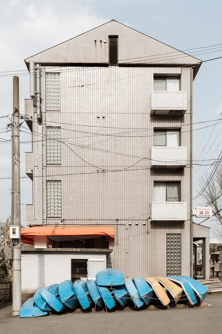 Boats and canoes stacked up in local street scene in Arashiyama Kyoto Japan. Photography by Darren Gill