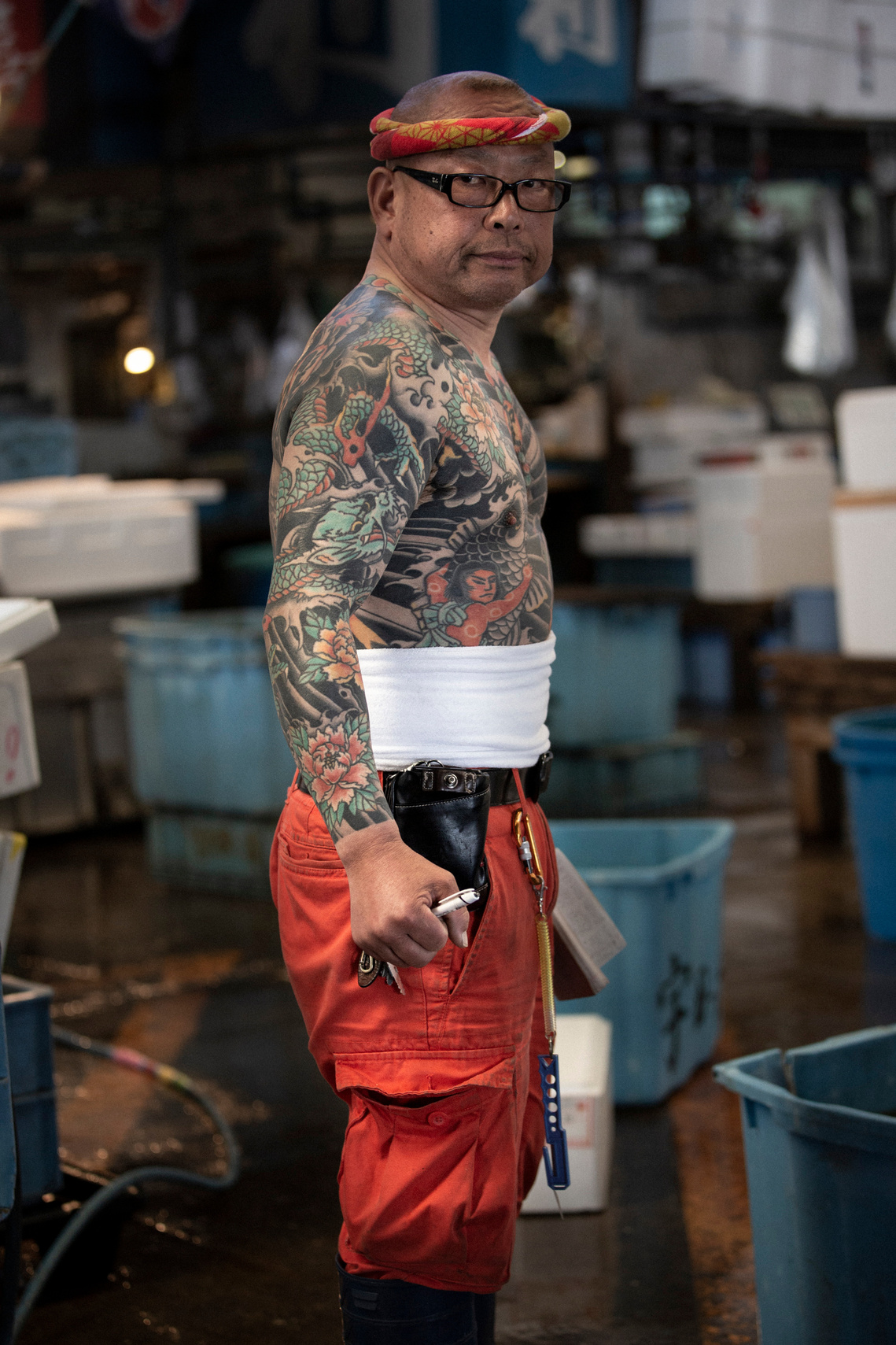 Portrait of tattooed Japanese worker at Tsukiji Fish market in Tokyo Japan. Photography by Darren Gill
