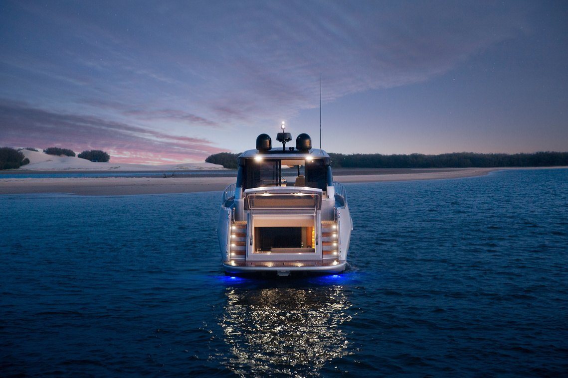Maritimo X50 luxury motor yacht anchored at dusk off an island in Queensland, Australia. Boat photography by Darren Gill