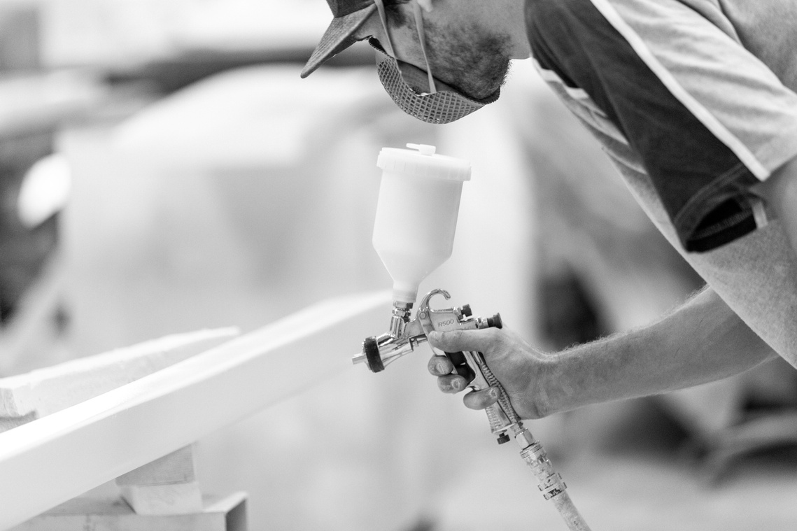 Maritimo Yachts production factory team member spraying. Photography by Darren Gill