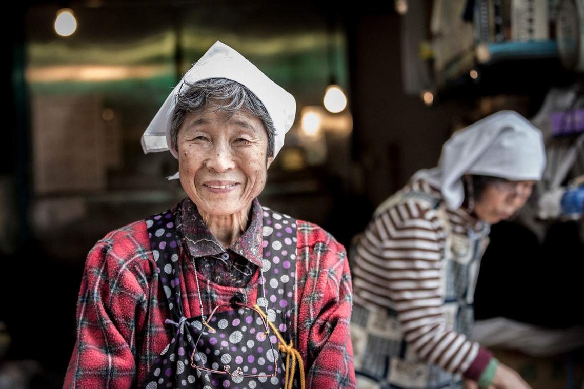 Portrait of elderly Japanese woman store owner at Tsukiji Fish Market in Tokyo Japan
