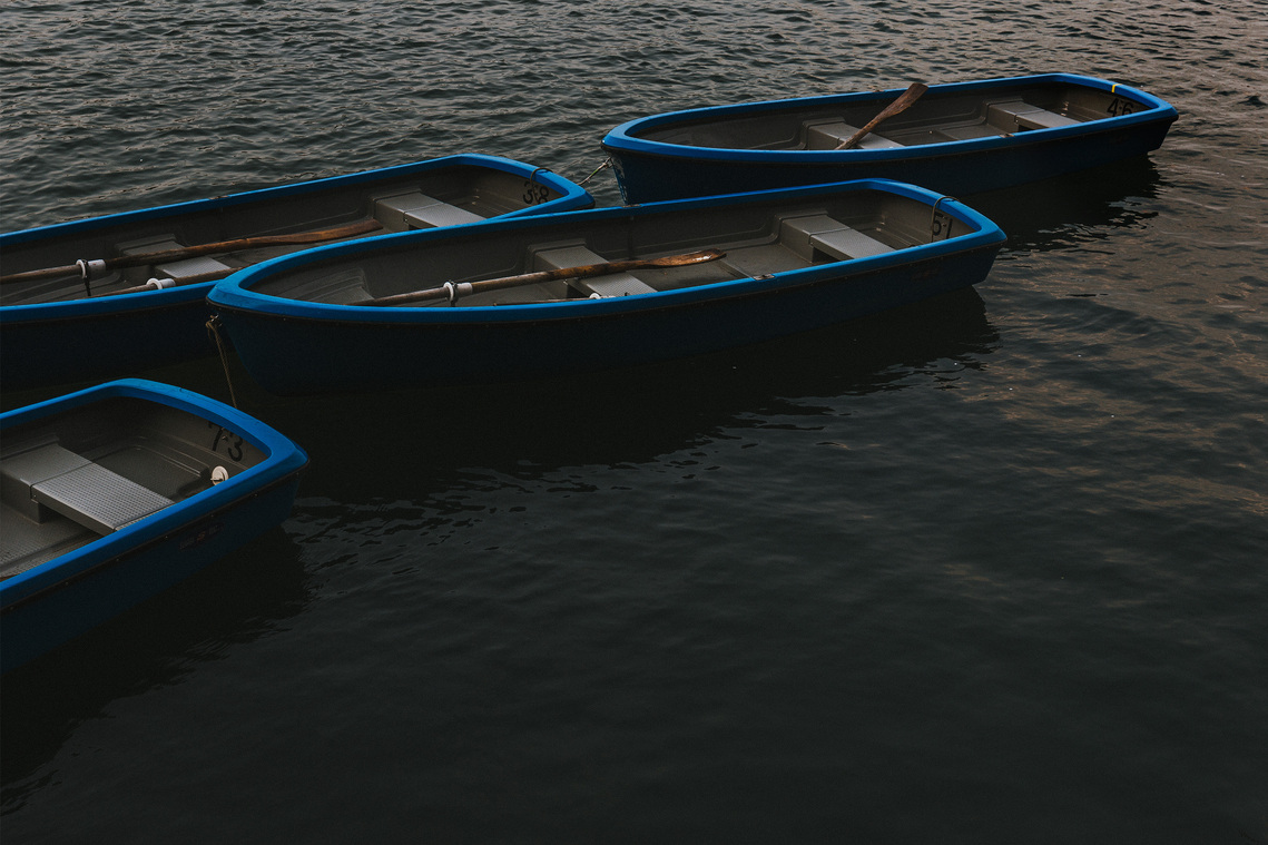 Empty blue boats on the Katsua River in Arashiyama Kyoto Japan. Photography by Darren Gill