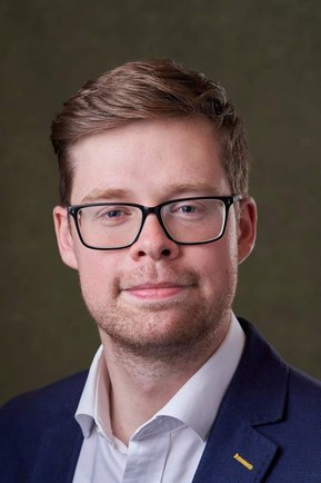 smiling man wearing glasses looking at the camera. Headshot photographer - Clive Allcorn
