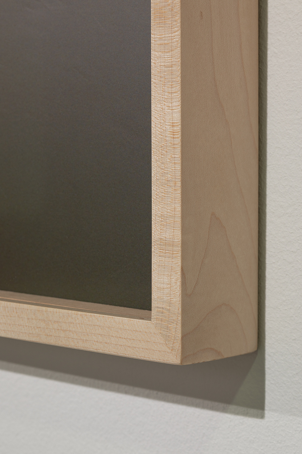 Detail of the photographic exhibition setup with fine art prints and custom frames at the Building Centre, London