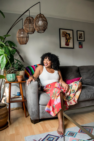 Portrait of a young black woman in her modern living room