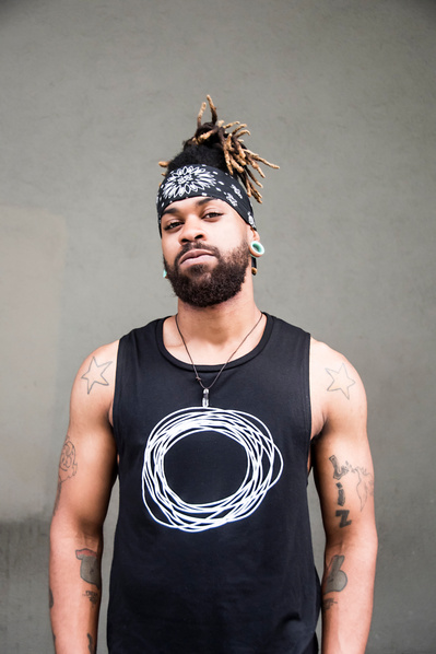 Portrait of a black yoga teacher with dreadlocks