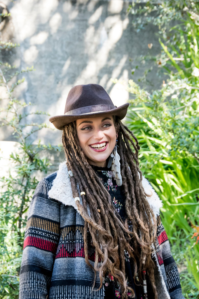 Portrait of young white woman with long dreadlocks