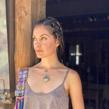 Indigenous young woman with box braids and crystal jewelry