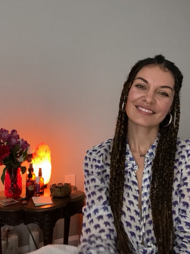 Ev Marquee, a young female healer with long box braids alongside a small altar