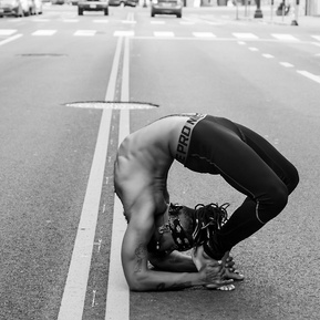 Black male yoga instructor in the middle of the street
