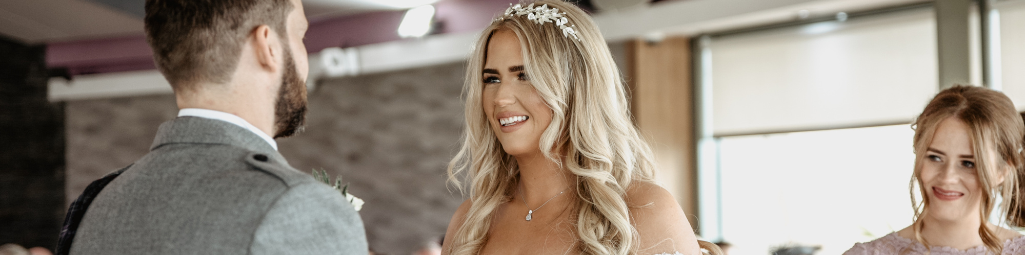 Bride smiling while looking at groom during ceremony. 