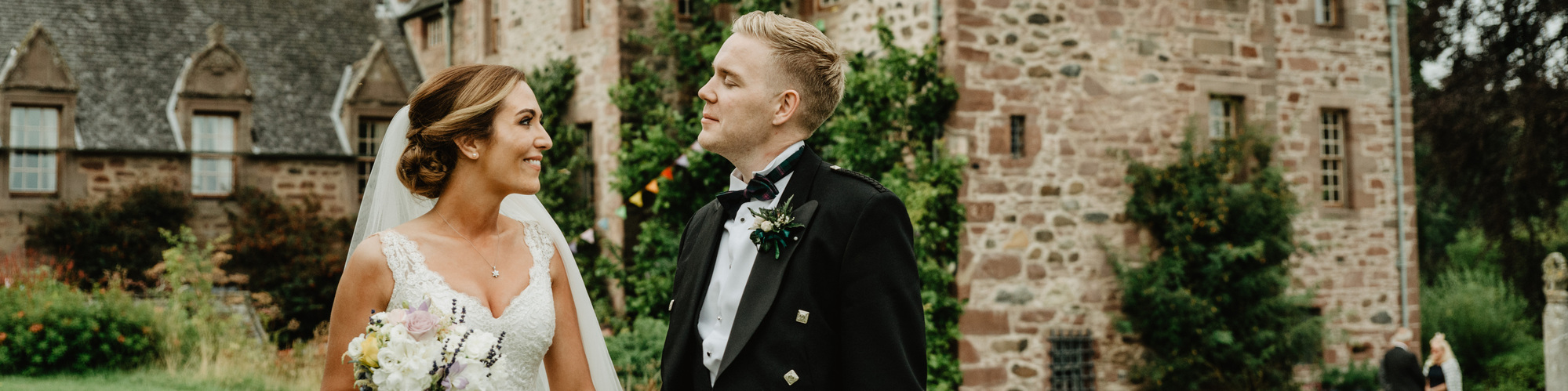 bride and groom holding hands looking at each other after ceremony