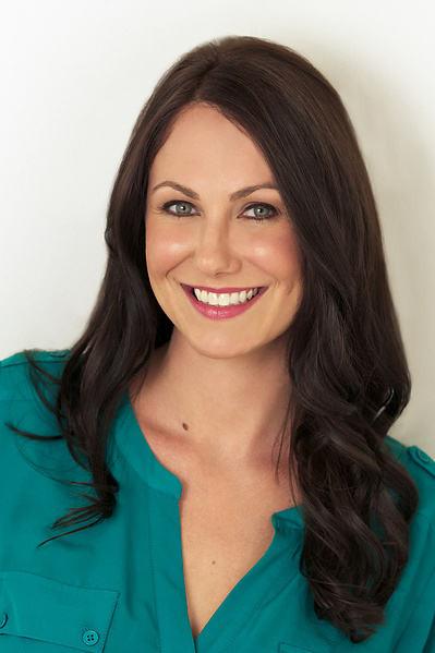 Young attractive brunette woman, Studio Headshot wearing green shirt