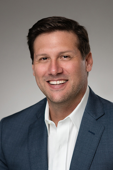 Handsome male executive Studio Headshot in dark suit and white shirt