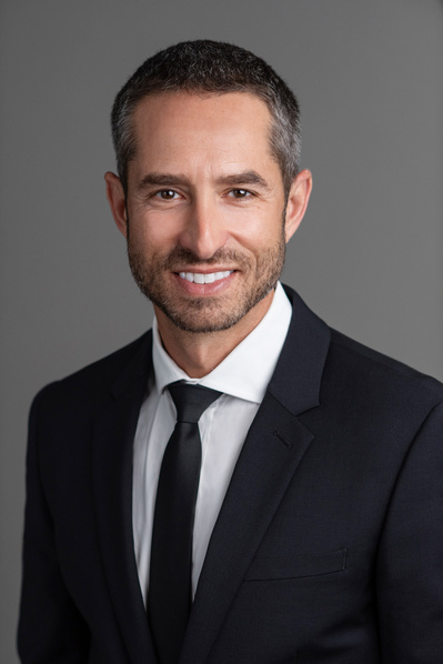 Color Headshot of Male financial expert in dark suit & tie, with facial hair