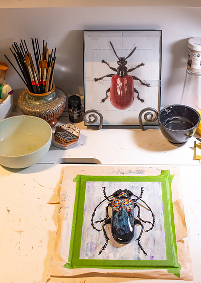 Artist's desktop with unfinished work laid out