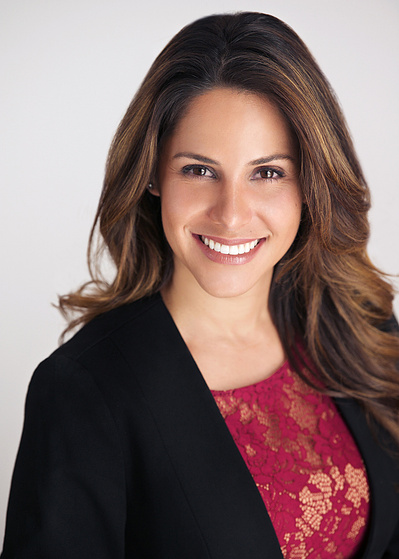 Pretty young brunette woman, Studio Headshot in dark suit and red top