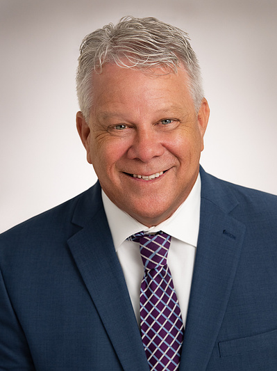 Older attractive gray haired male attorney, Studio portrait in dark suit