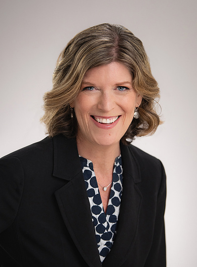 Female Attorney Headshot in dark suit with black & white top