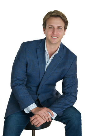 Young male attorney seated in blue suit