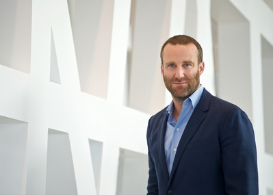 Male Executive Environmental Headshot in front of an white Art Wall