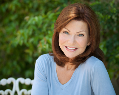 Older attractive female actress outdoor Headshot with blue sweater