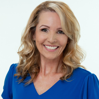 Pretty blond older female actress, Studio headshot wearing a blue dress