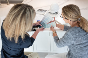 Kitchen designer comparing paint swatches with client