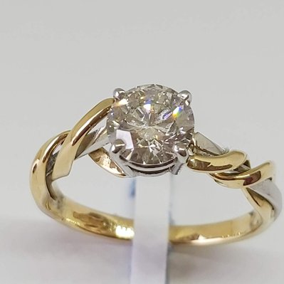 Beautiful diamond and gold engagement ring on white background